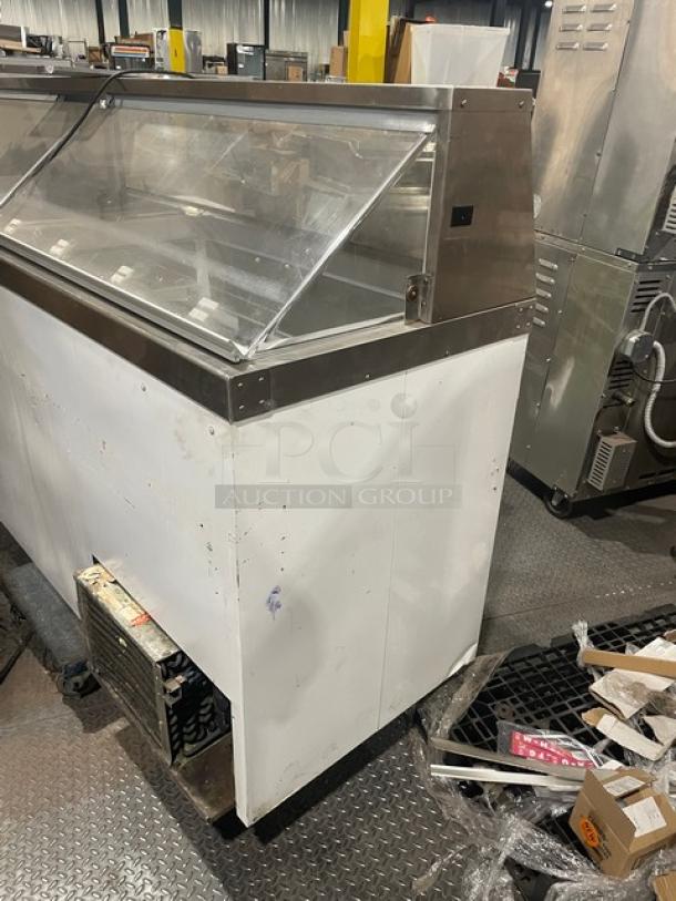 Master-Bilt commercial ice cream dipping cabinet with sneeze guard, rear lift-open access, and poly-coated wire rack.