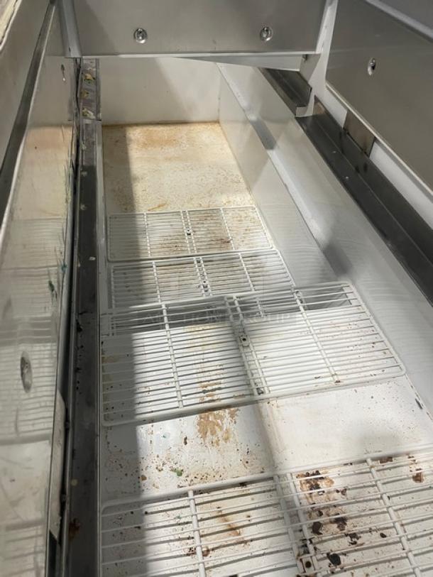 Master-Bilt commercial ice cream dipping cabinet with serve-over sneeze guard, rear lift-open access, and poly-coated wire rack. Signs of wear.