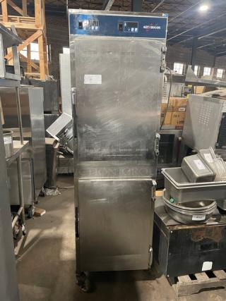 Alto-Shaam 1000-UP stainless steel mobile heated cabinet with dual compartments, Dutch doors, pan racks, 120V, on casters.