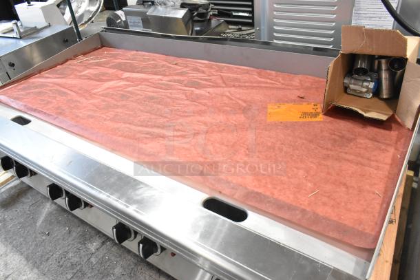 BRAND NEW Garland Stainless Steel Natural Gas Flat Top Griddle; scratch and dent condition, boxed components included.