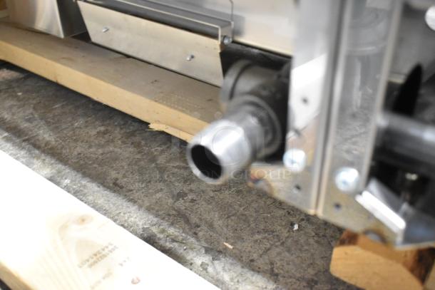 Brand new Garland stainless steel commercial countertop natural gas griddle, close-up view of assembly detail.