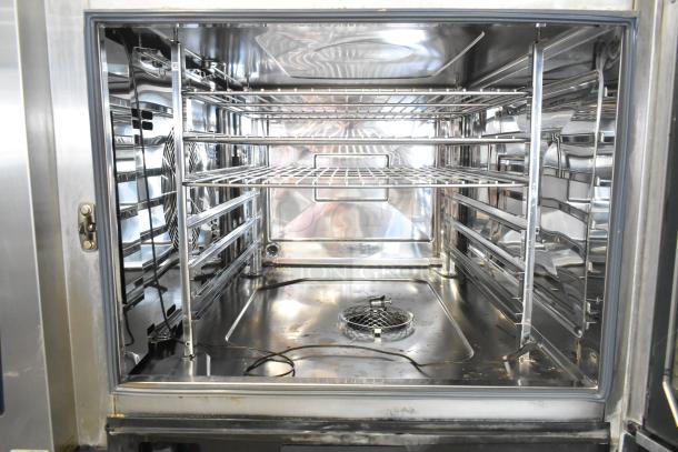 Inside view of a 2020 Rational iCombi Pro stainless steel convection oven, model LM100CE.AXXXX, showing clean interior racks.
