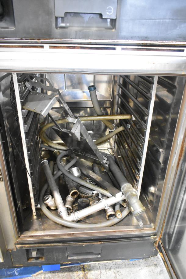 Two Rational 2020 iCombi Pro combi convection ovens in stainless steel, model LM100CE.AXXXX/LM100EE.AXXXX, with internal components and accessories shown.