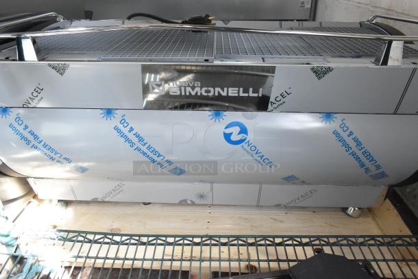 Brand new Nuova Simonelli 238AUWV3 Aurelia Wave stainless steel espresso machine, 3-group, with protective wrapping.