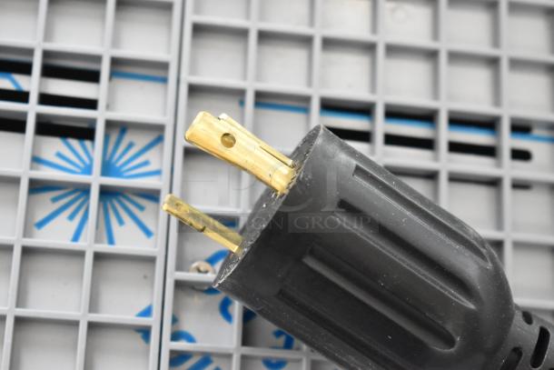 Close-up of a three-prong plug for Nuova Simonelli Aurelia Wave espresso machine, model 238AUWV3.