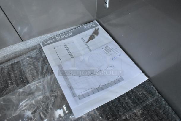 Alt text: Avantco 447AP23R user manual and test report on bubble wrap. Manual text includes cooler specs and instructions.