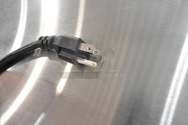 Black power plug on stainless steel surface of Avantco 178APT60MHC Commercial Prep Table. Model is 2024.