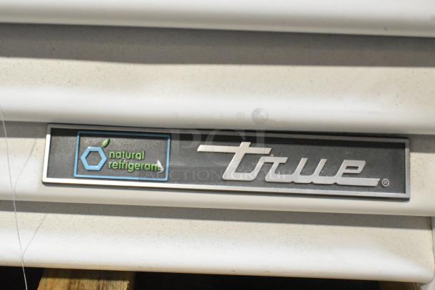 True TSCI-600R-G-PH cooler; natural refrigerant logo; brand new with minor scratches. Model plaque shown.