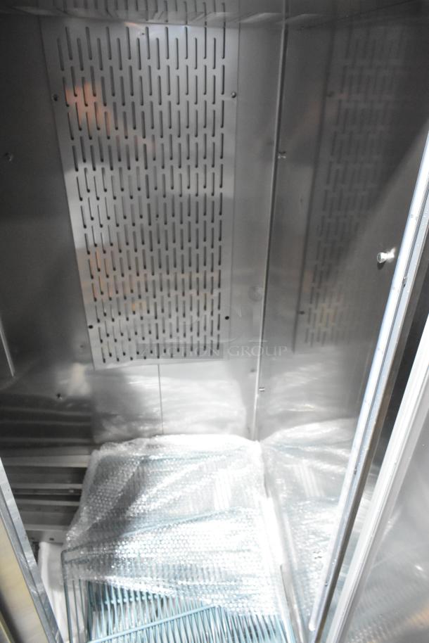 BRAND NEW Avantco 178Z2RHC stainless steel 2-door reach-in cooler with bubble wrap inside, on commercial casters.