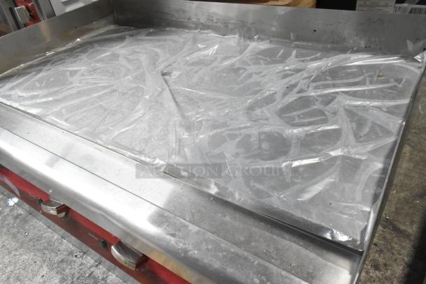 Brand new Avantco 177EG30N 30" electric countertop griddle, stainless steel, minor scratches, wrapped in plastic.