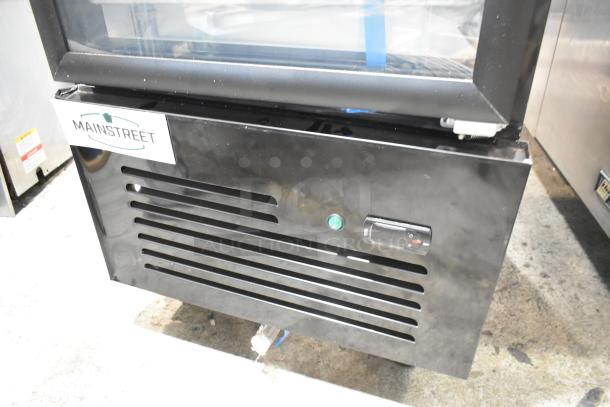 Brand new Mainstreet 829GMC12B metal commercial refrigerator, black single door with glass, 115V, slight scratches.