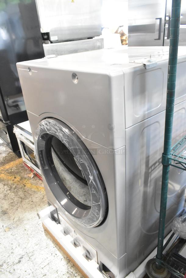 Brand new Crossover DLHS0817EC2 7 cu. ft. front load electric dryer, 120/208-240V, in silver, minor scratches visible.