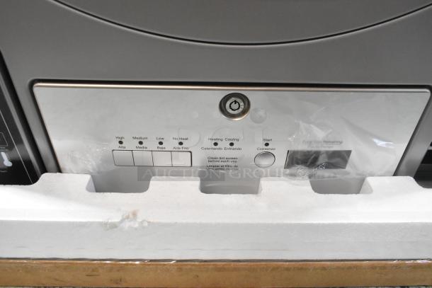 Crossover DLHS0817EC2 7 cu. ft. front load electric dryer, new condition with minor scratches, features control panel and settings.