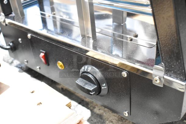Brand new Avantco 177HDC26 countertop heated display case. Features 3 shelves, sliding doors, temperature control knob.