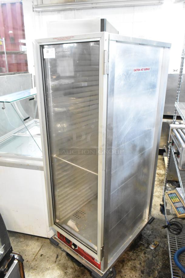 Avantco 177HEAT1836 heated holding cabinet on casters, metal exterior, 120 volts, 1 phase, caution labels visible.
