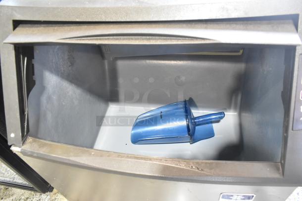Manitowoc UY09190A-161B ice machine interior with blue scoop. Stainless steel, 115 volts, 1 phase.