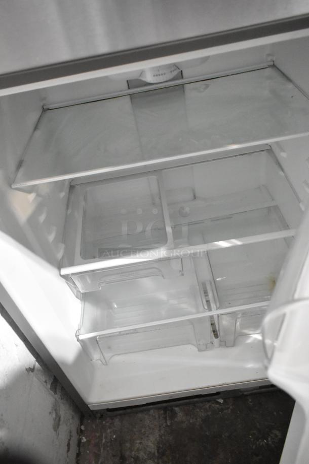 2016 Whirlpool WRT511SZDM00 stainless steel fridge/freezer interior, shelves and drawers visible, good condition.