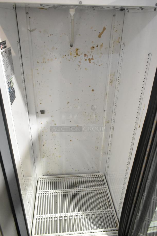 2023 True GDM-12-HC single door reach-in cooler with poly coated racks. Visible interior stains, 115 volts, 1 phase.