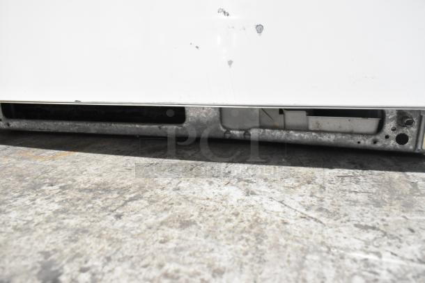 Whirlpool WRT511SZDW00 cooler base detail, showing vents and metal surface. 115 Volts, 1 Phase. Visible wear.