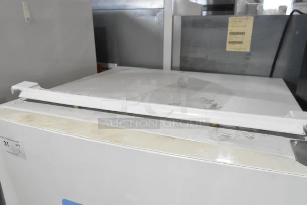 Whirlpool WRT511SZDW00 cooler with freezer, 115V, 1 phase. Visible wear on top, label indicates auction item 31.