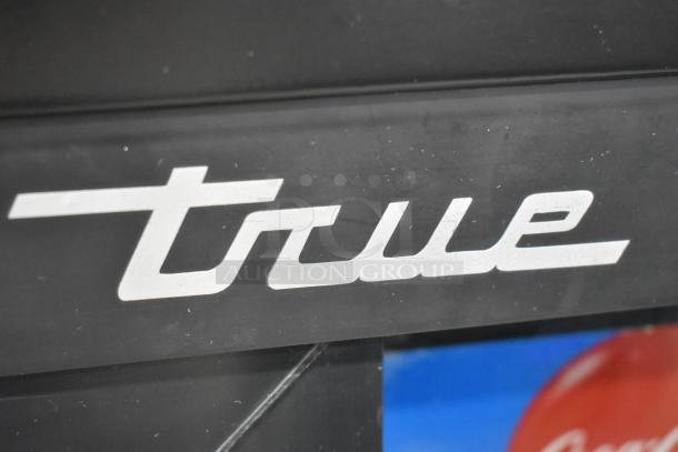 "True" logo on a 2019 True GDM-41SL-48-HC-LD commercial cooler. Metal construction, 2-door, poly-coated racks.