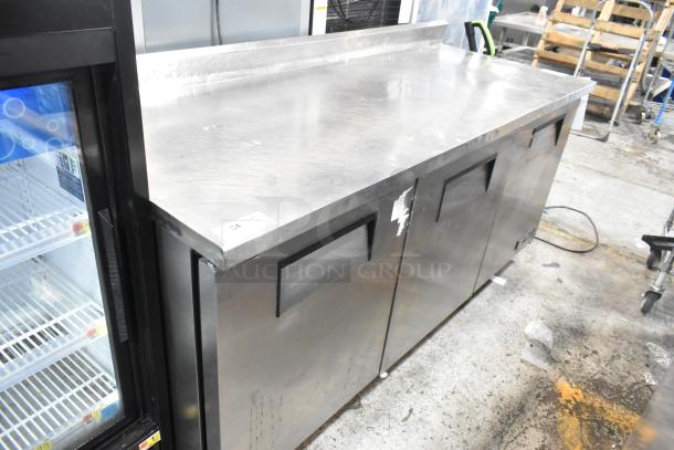True TWT-72 stainless steel commercial cooler with backsplash, 3 doors, on casters, used condition, 115V, 1 phase.