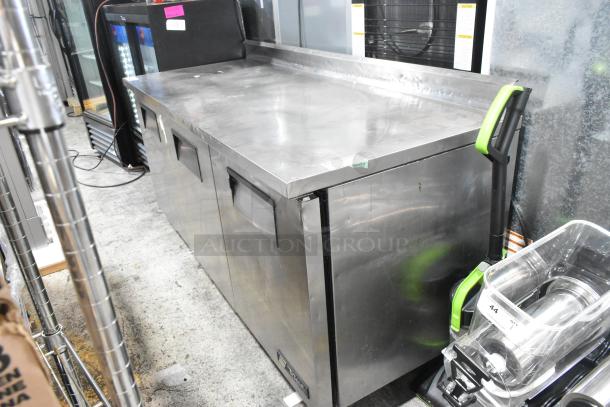 True TWT-72 stainless steel commercial work top cooler with back splash, 3 doors, on casters, 115V, 1 phase power, clean condition.