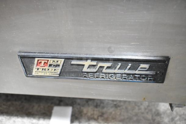 True TWT-72 stainless steel worktop cooler with backsplash, commercial casters, 115V, 1 Phase, model label visible.