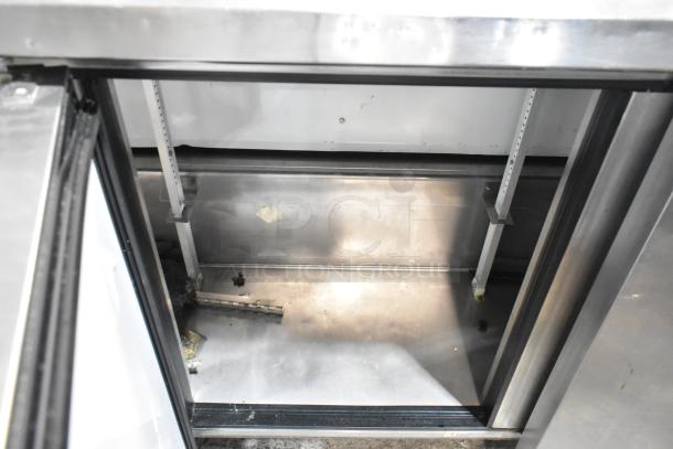 True TWT-72 stainless steel work top cooler, features back splash, on commercial casters. Visible interior in used condition.