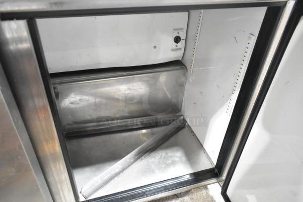 True TWT-72 stainless steel commercial cooler with back splash, on casters, showing interior shelving and temperature dial.