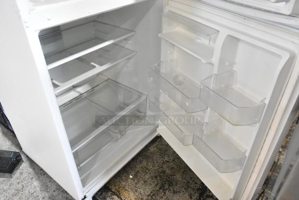 Whirlpool WRT511SZDW00 refrigerator with freezer, 115V, 1 phase. Features glass shelves and door bins. Appears in good condition.