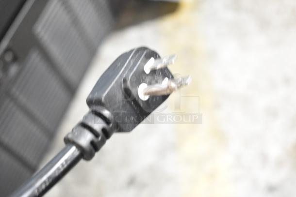 Close-up view of a power plug for the 2025 Whirlpool 21MSTFATR6 stainless steel cooler with freezer, 115 volts, 1 phase.