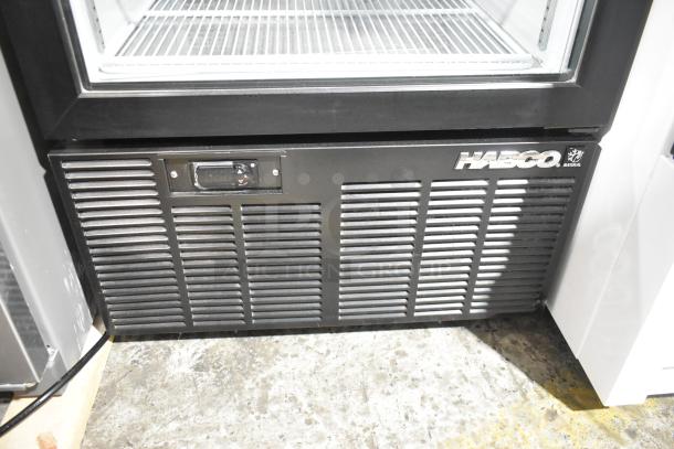 2019 Habco SE18 commercial single door cooler with poly-coated racks, 115V, 1 phase. Black metal exterior, excellent condition.