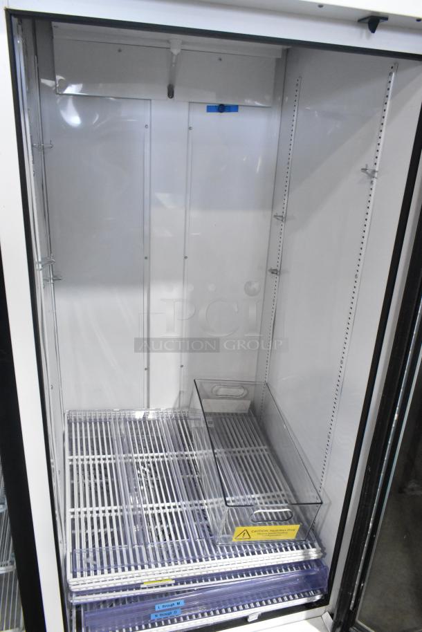 2021 True TSCI-600R-G-PH metal commercial cooler, single door, reach-in, with poly-coated racks, 115V, 1 phase.