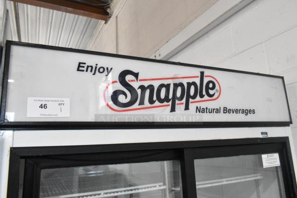 Beverage Air MT38 2-door cooler, metal, showcases Snapple branding. Features poly-coated racks. 115V, 1 phase. Auction tag visible.