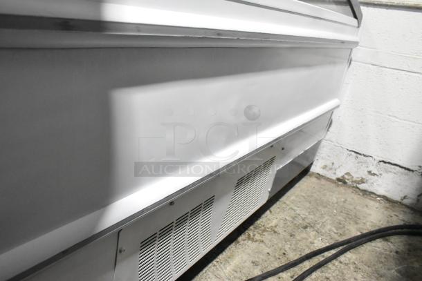 Metal commercial horizontal freezer merchandiser, durable construction, vented cover, on commercial casters for mobility.