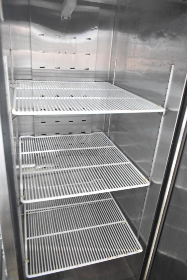 Atosa stainless steel single door cooler with poly-coated racks, commercial casters, 115 volts, 1 phase power.