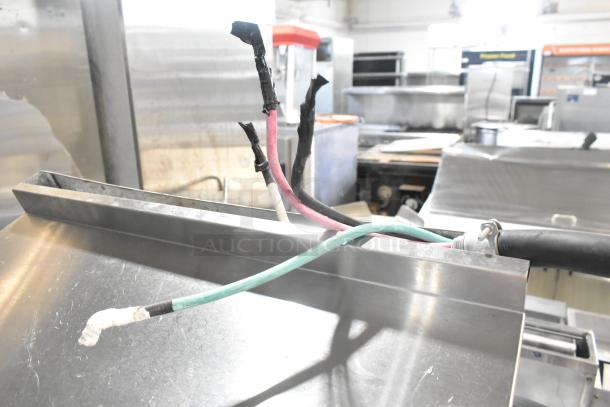 Stainless steel Cookline ER24-208 commercial range wiring and back section, showcasing power cables, over shelf, and back splash.