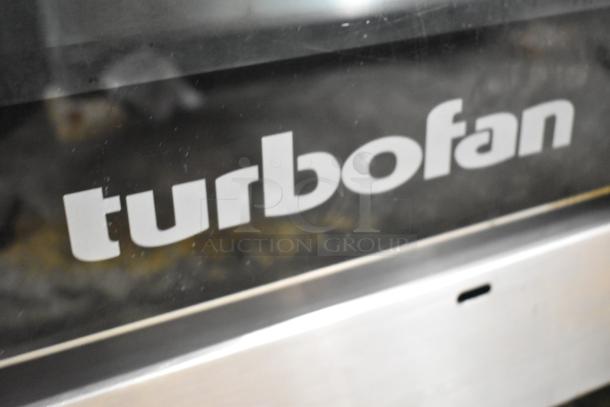 Moffat Turbofan stainless steel convection oven with view-through door and metal racks. Electric powered, half-size model.