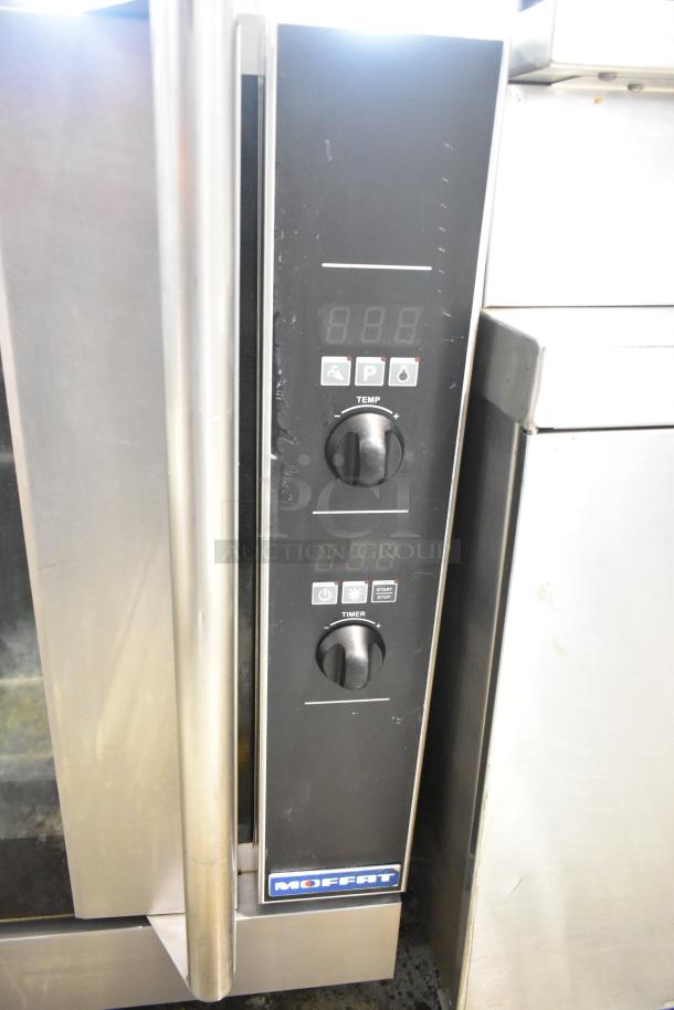 Moffat Turbofan commercial convection oven, stainless steel, half size, with view-through door, metal racks, control panel visible.