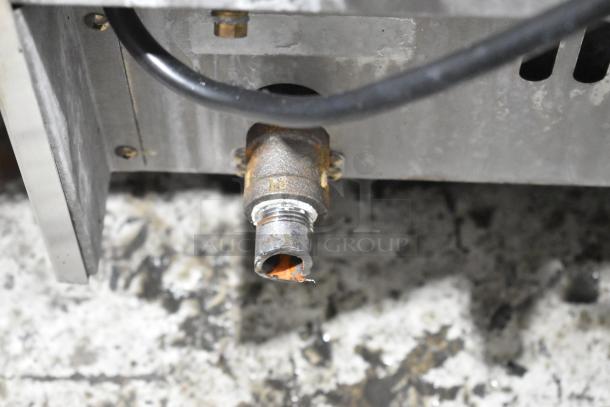Close-up of a connector on a Moffat Turbofan convection oven, stainless steel body with electric power.
