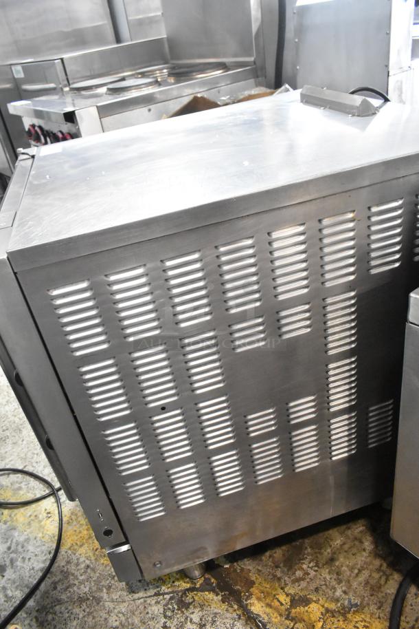 Moffat Turbofan stainless steel half-size convection oven with vented side panel, electric powered, metal oven racks.