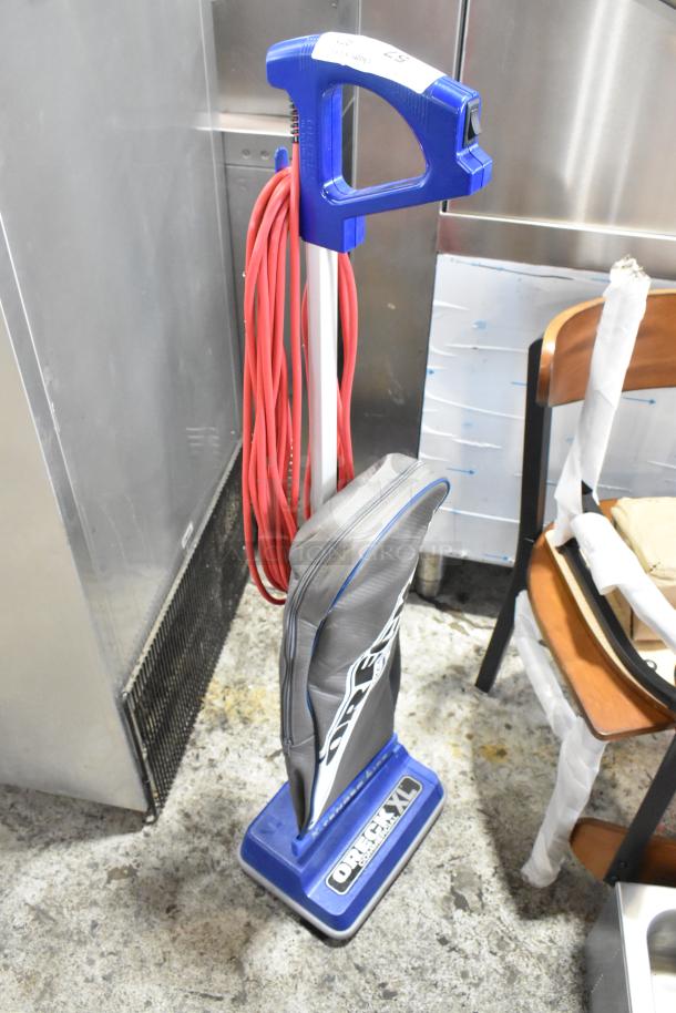 Brand new Oreck XL2100RHS upright vacuum, lightweight, 12", 120V, bagged design, noted as scratch and dent.