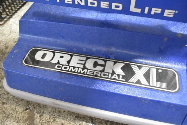 Oreck XL2100RHS 12" Lightweight Bagged Vacuum Cleaner, new condition with minor scratches. Features "Commercial XL" branding.