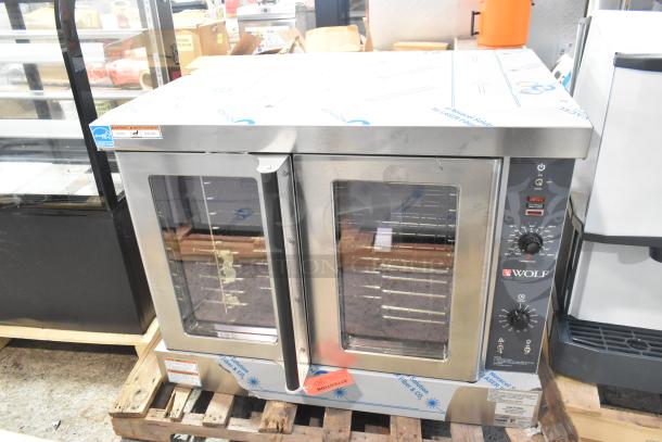 Brand new Wolf WC4GD-21D3 stainless steel convection oven with view-through doors, metal racks, and thermostatic controls.