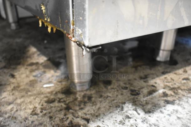 Asber stainless steel commercial deep fat fryer with visible wear and grease buildup near the bottom edge.