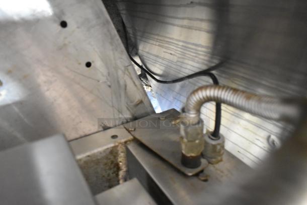 Interior view of Cleveland KGT-12-T steam kettle connections, showing metal tubing and wiring in used condition.