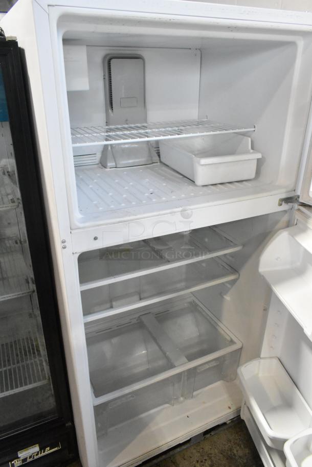 Maytag M1TXEGMYW01 fridge with freezer, clean interior, includes shelves and bins, for 115 volts, 1 phase power.