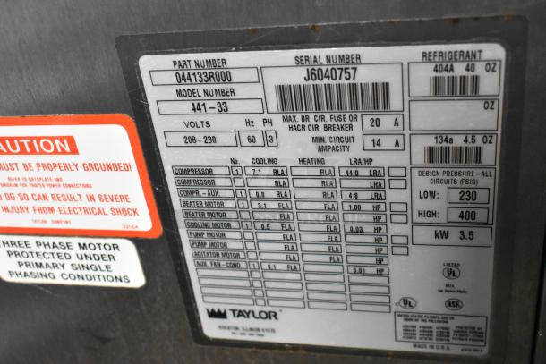 Taylor 441-33 stainless steel water-cooled soft serve machine label detailing 208-230V, 3-phase, with safety warnings.