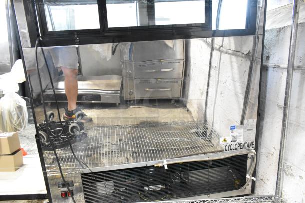 Avantco 193CAC48B black metal refrigerated air curtain merchandiser, 47" wide, on casters. Includes Cyclopentane label.